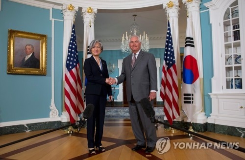 In this AFP photo, South Korean Foreign Minister Kang Kyung-wha shakes hands with U.S. Secretary of State Rex Tillerson ahead of their meeting at the State Department on June 28, 2017. (Yonhap)