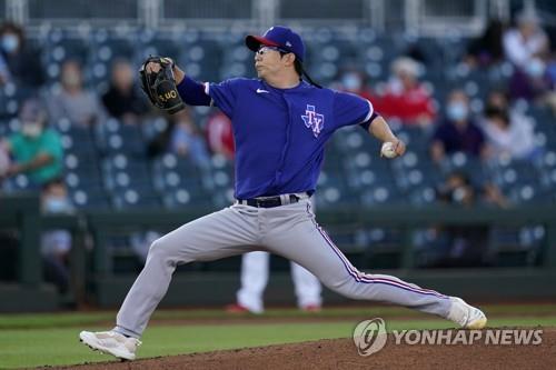 In this Associated Press photo, Yang Hyeon-jong of the Texas Rangers pitches against the Cincinnati Reds in the bottom of the first inning of a major league spring training game at Goodyear Stadium in Goodyear, Arizona, on March 24, 2021. (Yonhap)