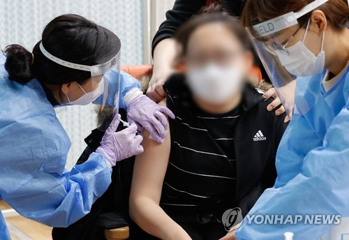 A student receives a coronavirus vaccine at her school in this undated file photo. (Yonhap)