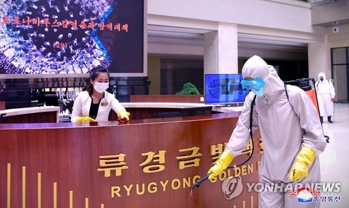 In this photo released by the North's official Korean Central News Agency on June 15, 2022, North Korean workers disinfect the Ryugyong Golden Mall in Pyongyang. (For Use Only in the Republic of Korea. No Redistribution) (Yonhap)