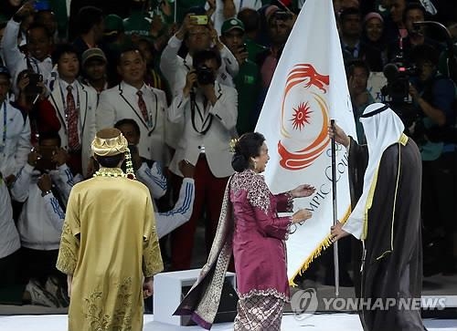 2014 인천아시안게임 폐회식에서 알사바 OCA 의장이 차기 개최국인 인도네시아 대표에게 OCA기를 전달하고 있다. 2014.10.4