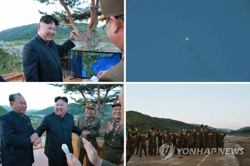 지난 5월 화성-12형 시험발사 성공에 기뻐하는 김정은