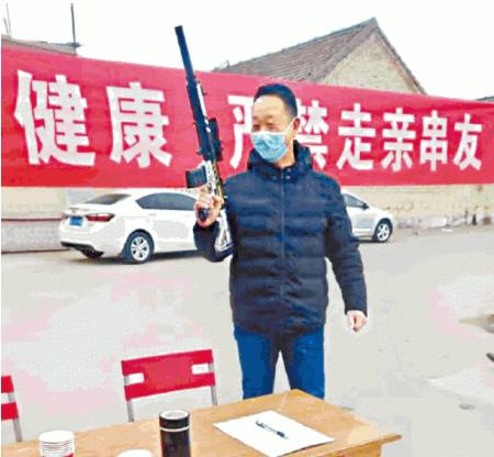 중국의 한 마을에서 총기 모양의 물건을 들고 후베이인의 진입을 막는 모습