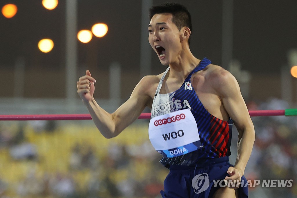 In this AFP photo, Woo Sang-hyeok of South Korea celebrates after a successful attempt during the men's high jump event at the World Athletics Diamond League competition at Khalifa International Stadium in Doha on May 13, 2022. (Yonhap)