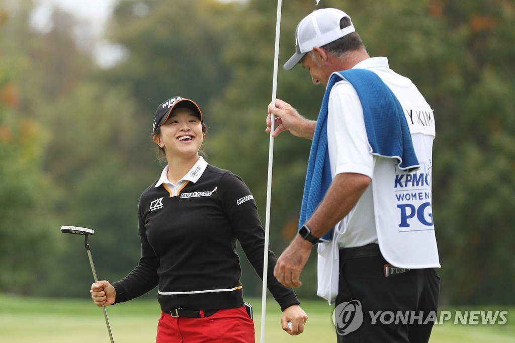 In this Getty Images photo, Kim Sei-young of South Korea (L) celebrates on the 18th green next to her caddie, Paul Fusco, after winning the KPMG Women's PGA Championship at Aronimink Golf Club in Newtown Square, Pennsylvania, on Oct. 11, 2020. (Yonhap)