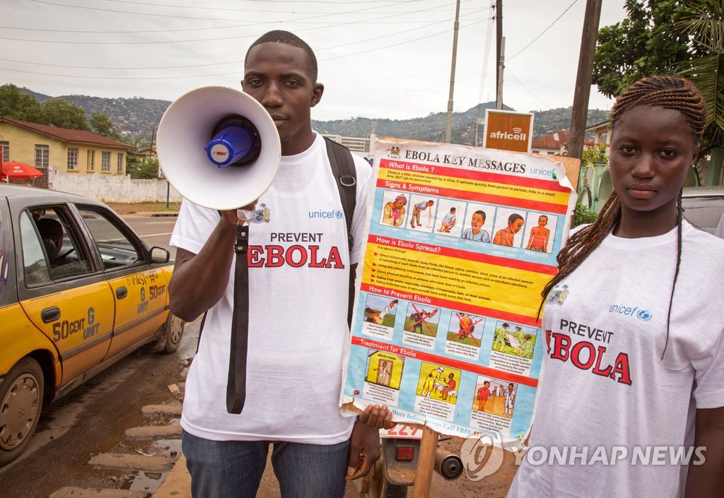서부 아프리카에서 에볼라 바이러스가 급속히 번지는 가운데 6일(현지시간) 시에라리온 수도 프리타운 거리에서 두 남녀가 에볼라 예방정보 등을 담은 널판지와 확성기를 들고 캠페인을 벌이고 있다. (AP=연합뉴스 자료사진)