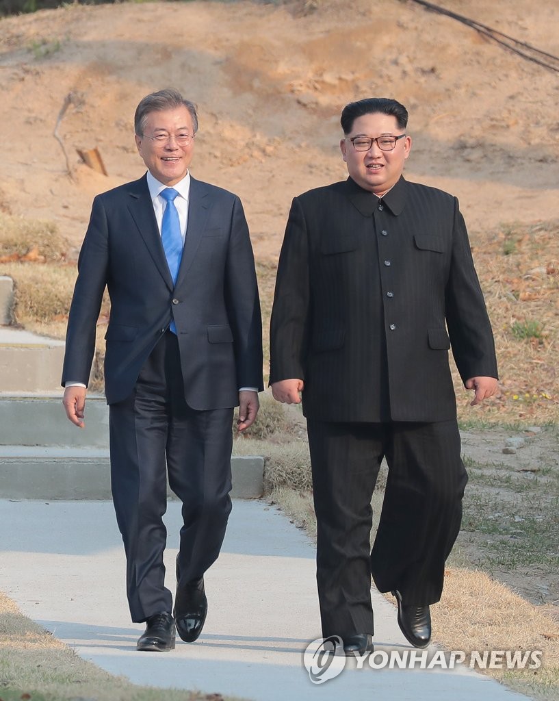 South Korean President Moon Jae-in (L) and North Korean leader Kim Jong-un walk on the southern side of the truce village of Panmunjom in the Demilitarized Zone on April 27, 2018, as they meet to hold the first inter-Korean summit talks in over a decade. (Yonhap)