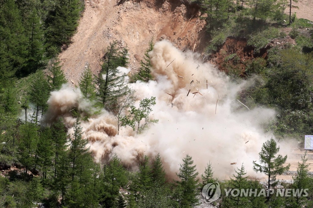 The North Portal, also known as Tunnel No. 2, of North Korea's only known nuclear test site, Punggye-ri, is blown up on May 24, 2018, in this press pool photo. South Korean journalists covering the process said the demolition of the site was carried out in a series of explosions over several hours on the day. The North's Korean Central News Agency said tunnels, all kinds of equipment, the control center and a research institute at the site were dismantled. Press members from South Korea, China, Russia, the United States and Britain covered the process at the site in Kilju County, North Hamgyong Province in the country's northeast. (Yonhap)