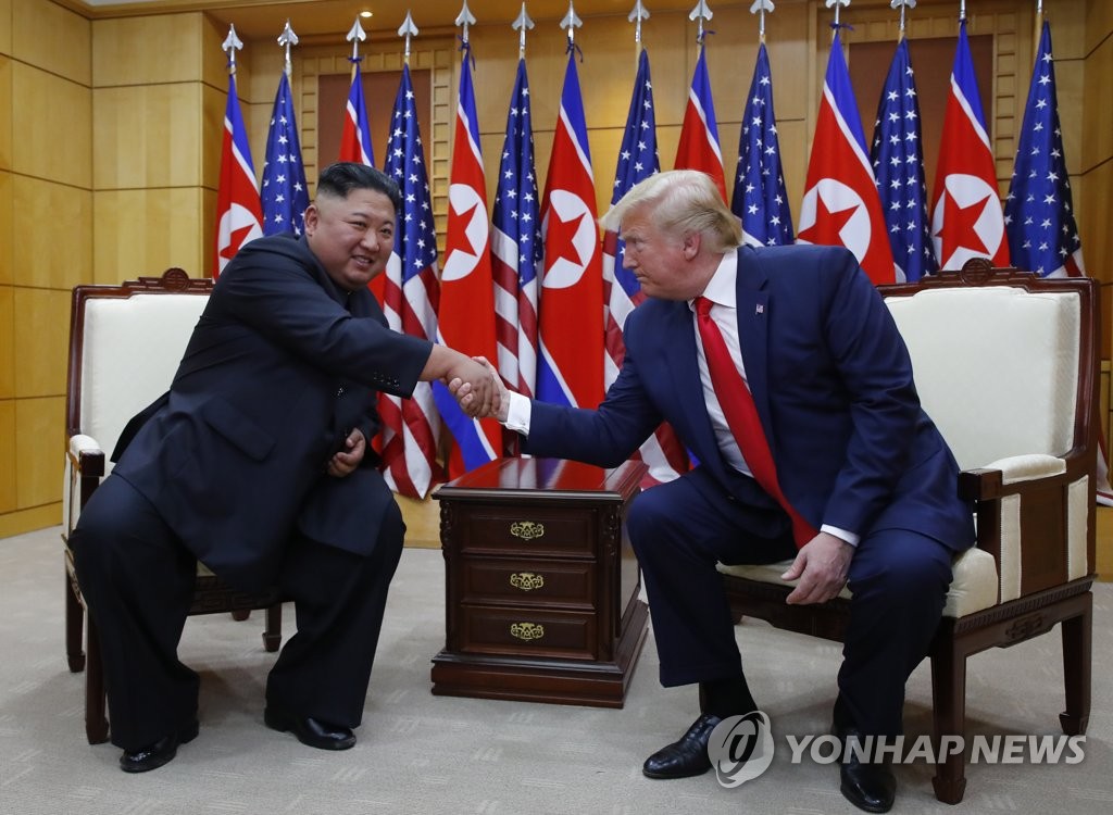 In the file photo, taken June 30, 2019, U.S. President Donald Trump (R) and North Korean leader Kim Jong-un shake hands during their third and last meeting held at the Freedom House on the South Korean side of Panmunjom inside the Demilitarized Zone that separates the two Koreas. (Yonhap)