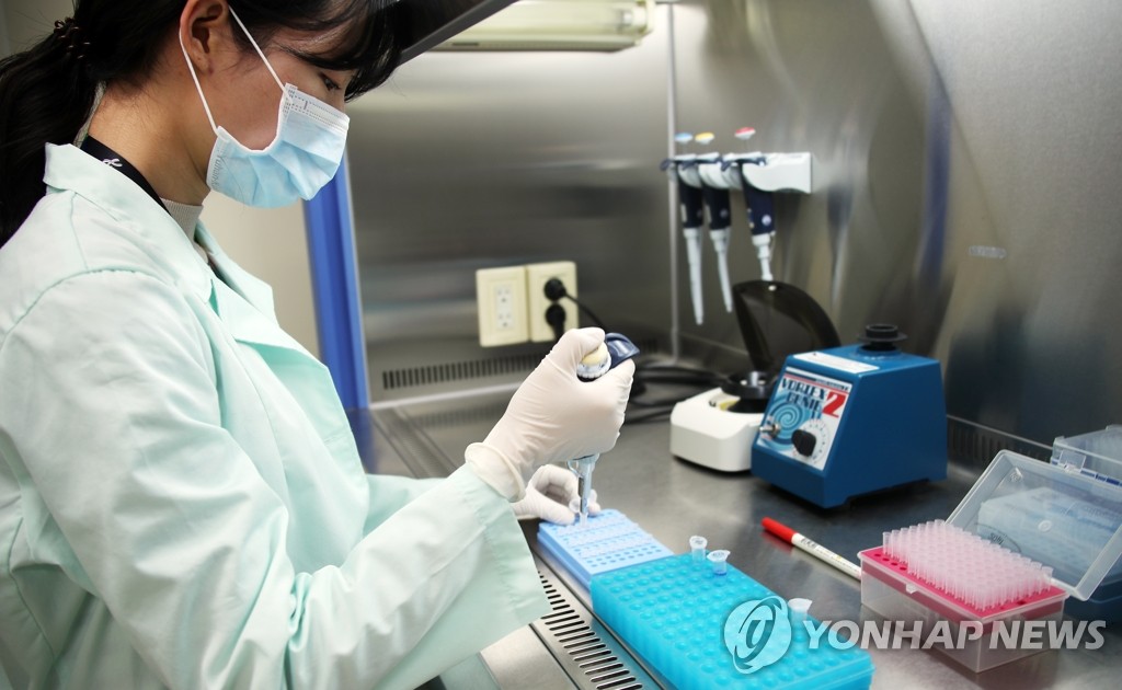 A researcher at Kogene Biotech Co. tests COVID-19 diagnostic reagents at the company's research facility in Seoul on Feb. 5, 2020.