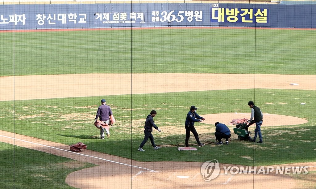 In this file photo from March 30, 2020, members of the NC Dinos' grounds crew work on the infield grass at Changwon NC Park in Changwon, 400 kilometers southeast of Seoul. (Yonhap)