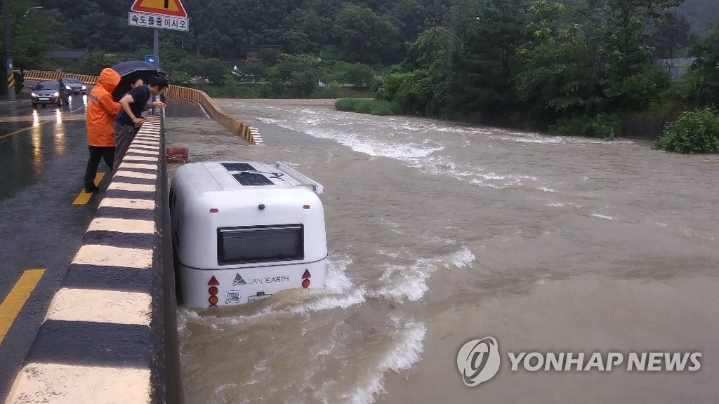 Camper trailer caught in flooded stream Camper trailer caught in flooded stream