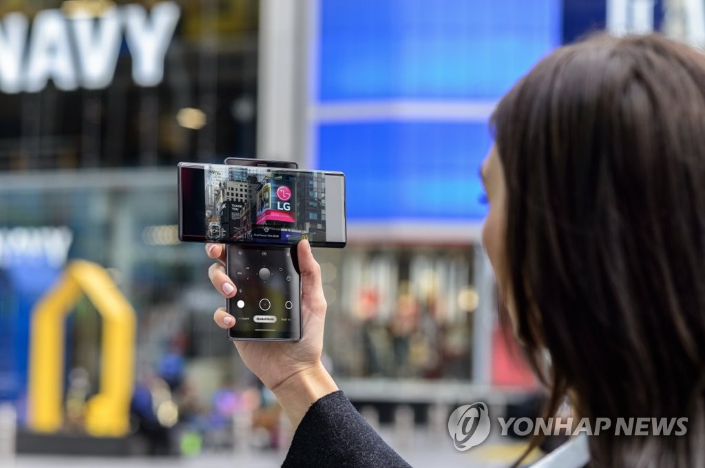 This file photo, provided by LG Electronics Inc. on Oct. 16, 2020, shows a model holding the company's dual-screen smartphone, the Wing. (PHOTO NOT FOR SALE) (Yonhap)