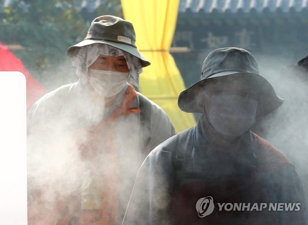 Buddhist monks wearing protective masks enter a temple in southern Seoul on Oct. 27, 2020. (Yonhap)