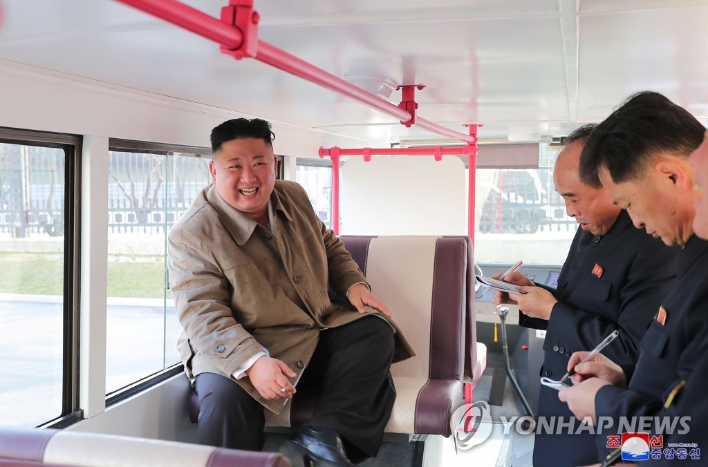 North Korean leader Kim Jong-un (L) sits inside a trial version of a double-decker bus in Pyongyang on March 25, 2021, as he inspects the trial versions of a passenger bus and a double-decker, developed by the Pyongyang General Passenger Service Enterprise and the Pyongyang City Bus Factory, in this photo released by the North's official Korean Central News Agency. Kim did not oversee the launch of a new type of missile that the North conducted the same day. (For Use Only in the Republic of Korea. No Redistribution) (Yonhap)