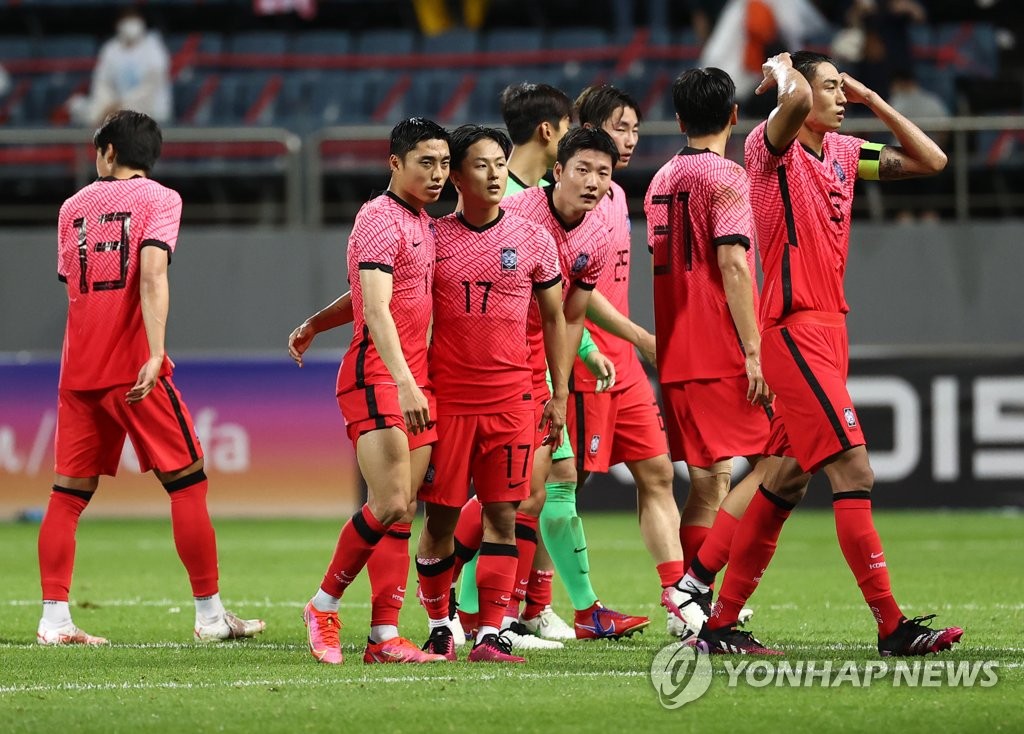 In this file photo from June 15, 2021, members of the South Korean men's Olympic football team celebrate their 2-1 victory over Ghana in a friendly match at Jeju World Cup Stadium in Seogwipo, Jeju Island. (Yonhap)