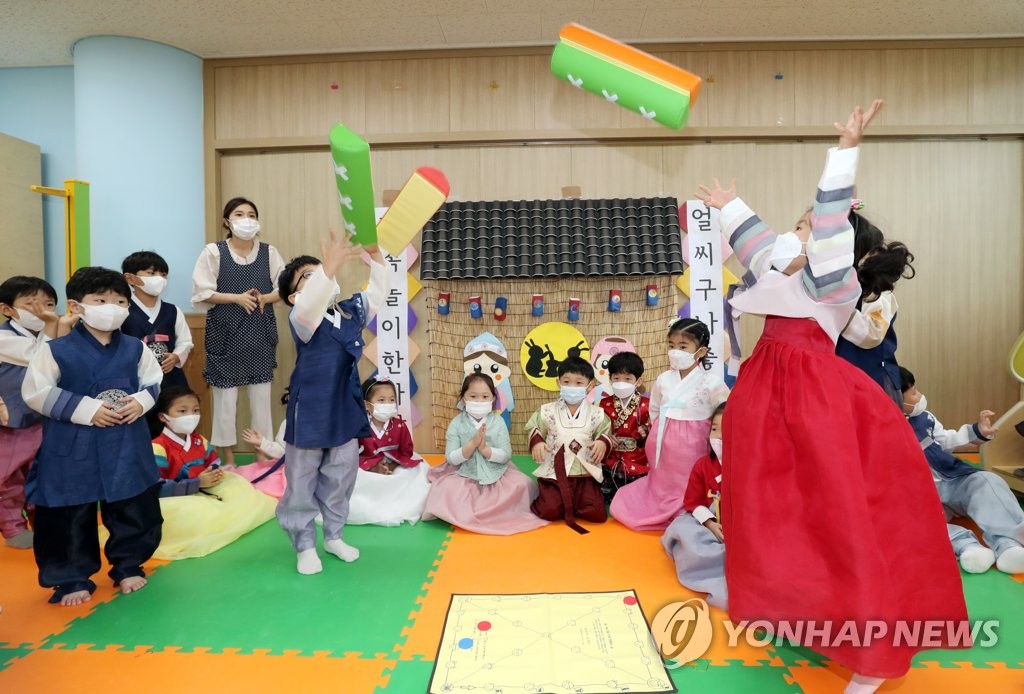 Niños con 'hanbok' jugando al 'yut' Niños con 'hanbok' jugando al 'yut'