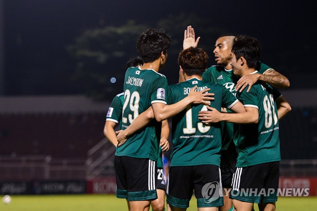 In this May 1, 2022, file photo provided by the Asian Football Confederation (AFC), Kim Bo-kyung of Jeonbuk Hyundai Motors (C) is congratulated by teammates after scoring a goal against Yokohama F. Marinos during the clubs' Group H match at the AFC Champions League at Thong Nhat Stadium in Ho Chi Minh City. (PHOTO NOT FOR SALE) (Yonhap)