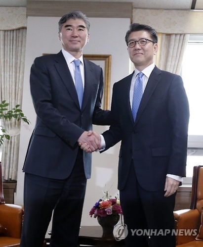 Amb. Sung Kim (L), U.S. special envoy for North Korea policy, shakes hands with his South Korean counterpart, Kim Hong-kyun, during a meeting in Seoul in March.