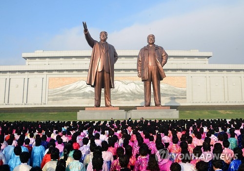 This file photo, released by the North's official Korean Central News Agency on Nov. 14, 2016, shows people offering flowers at the bronze statues of founder Kim Il-sung and his late son Kim Jong-il on Mansudae Hill in Pyongyang. (For Use Only in the Republic of Korea. No Redistribution) (Yonhap)