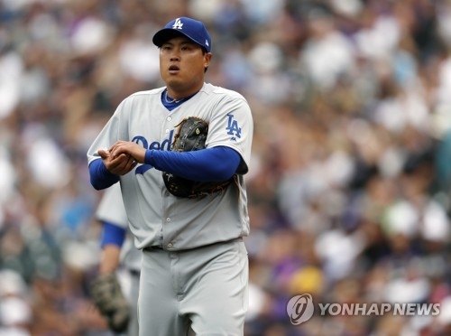 In this Associated Press photo, Ryu Hyun-jin of the Los Angeles Dodgers reacts after giving up a solo home run to Colorado Rockies' Dustin Garneau in the fifth inning of their Major League Baseball game on April 7, 2017, at Coors Field in Denver. (Yonhap)