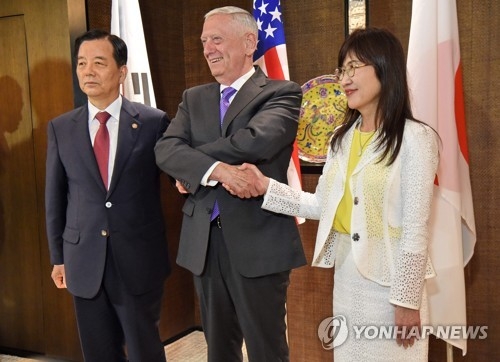 South Korean Defense Minister Han Min-koo (L) poses for a photo with his U.S. and Japanese counterpars -- Jim Mattis and Tomomi Inada -- before talks in Singapore on June 3, 2017.