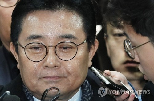 Jun Byung-hun, former senior aide to President Moon Jae-in, is swamped by reporters asking him questions as he appears at the Seoul Central District Court for his arraignment hearing over a bribery case on Nov. 24, 2017. (Yonhap) 