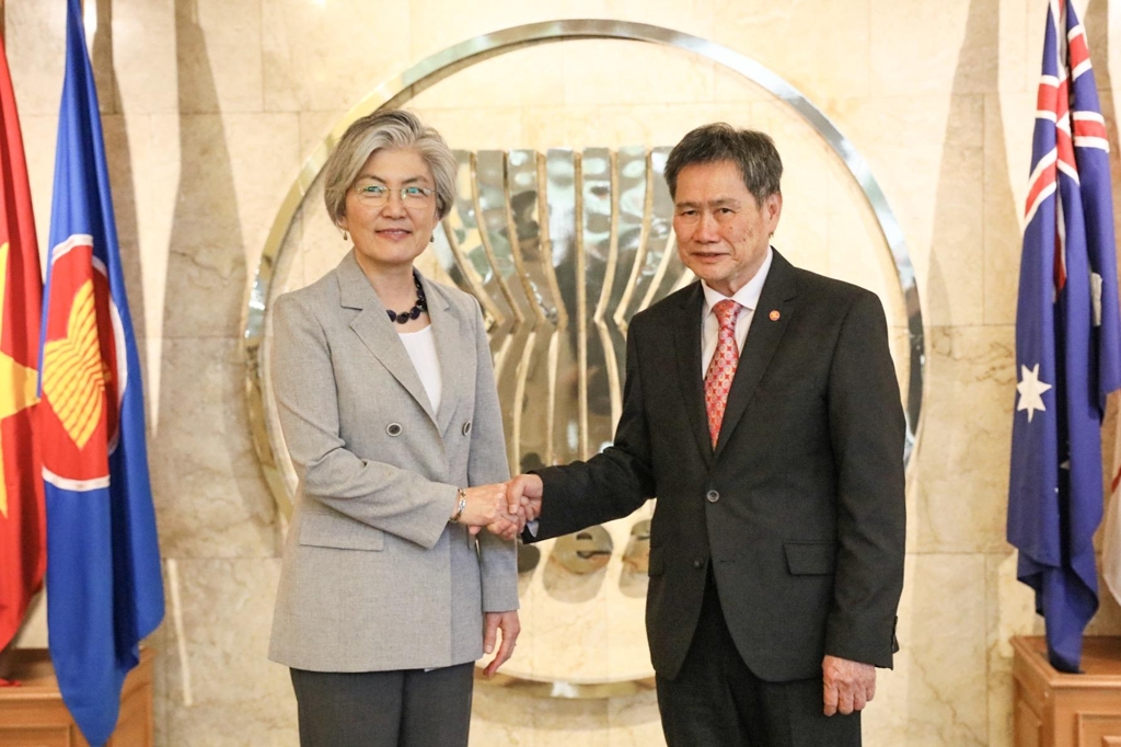 In this photo, provided by Seoul's foreign ministry, Foreign Minister Kang Kyung-wha (L) poses for a photo with the Association of Southeast Asian Nations' Secretary-General Lim Jock Hoi in Jakarta on April 8, 2019. (Yonhap)