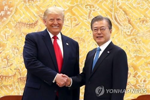 South Korean President Moon Jae-in and U.S. President Donald Trump shake hands with each other during a Cheong Wa Dae meeting in Seoul on June 30, 2019. (Yonhap)
