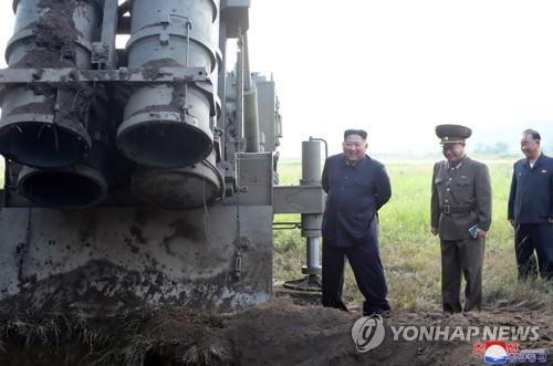 North Korean leader Kim Jong-un (L) stands next to a super-large multiple rocket launcher in South Pyongan Province in western North Korea on Sept. 10, 2019, as he oversees the launcher's testing, in this photo released by the North's Korean Central News Agency on Sept. 11. (For Use Only in the Republic of Korea. No Redistribution) (Yonhap)