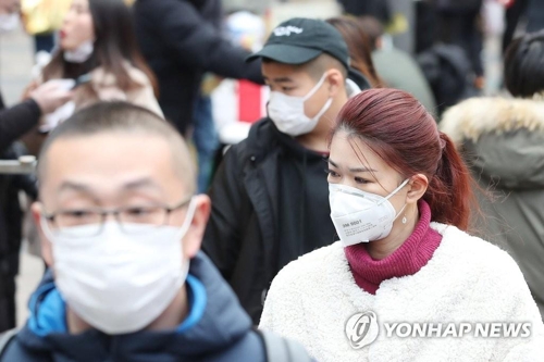 Tourists wearing masks visit Gyeongbok Palace in central Seoul on Jan. 27, 2020. (Yonhap)