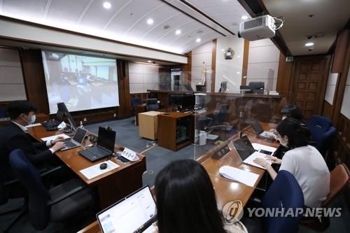 Reporters wait for the hearing to begin on the extradition case of Son Jung-woo, who ran one of the world's biggest child porn sites, at the Seoul High Court on July 6, 2020. (Yonhap)