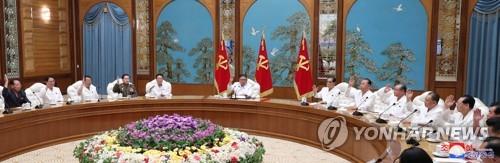 This photo, released by the Korean Central News Agency (KCNA) on July 26, 2020, shows an emergency politburo meeting of the Workers' Party under way over the new coronavirus. At the center is North Korean leader Kim Jong-un. The KCNA said Kim adopted a decision to shift to a "maximum emergency system" against the coronavirus in the meeting. (For Use Only in the Republic of Korea. No Redistribution) (Yonhap)
