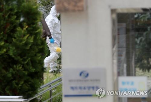 A disinfection worker enters a nursing hospital located in the southern port city Busan's Mandeok neighborhood on Oct. 14, 2020. (Yonhap) 