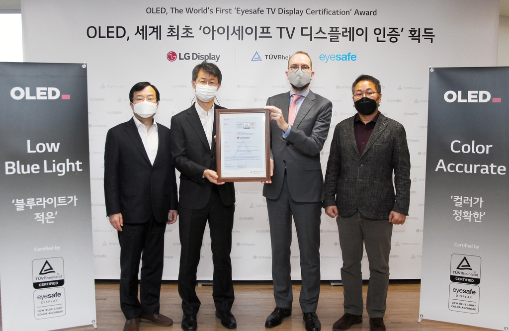 This photo provided by LG Display Co. on Jan. 5, 2020, shows officials from LG Display and TUV Rheinland posing for a photo in Seoul after the company's OLED panel won Eyesafe certification. (PHOTO NOT FOR SALE) (Yonhap)