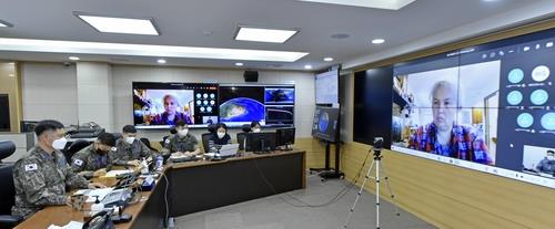 Members of the Korea Space Operations Center hold a videoconference with officials of the U.S.-led Combined Space Operations Center on May 7, 2021, to discuss falling debris from a Chinese space rocket, in this photo provided by South Korea's Air Force. (PHOTO NOT FOR SALE) (Yonhap) 