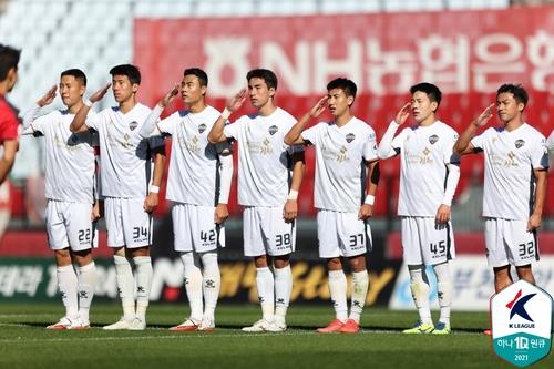 Gimcheon Sangmu players stand for the national anthem before the start of their K League 2 match against Bucheon FC at Bucheon Stadium in Bucheon, Gyeonggi Province, on Oct. 17, 2021, in this photo provided by the Korea Professional Football League. (PHOTO NOT FOR SALE) (Yonhap)