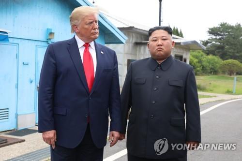 In this file photo, taken June 30, 2019, then U.S. President Donald Trump (L) stands with North Korean leader Kim Jong-un before their talks at the Freedom House on the southern side of the truce village of Panmunjom in the Demilitarized Zone, which separates the two Koreas. (Yonhap)