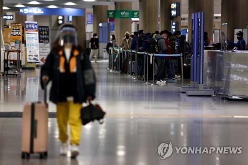 Amid growing woes over the spread of omicron, a new variant of COVID-19, foreign arrivals wait for buses at Incheon International Airport, west of Seoul, on Nov. 30, 2021. (Yonhap)