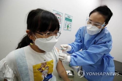 This image provided by a ward office in Gwangju shows a child getting a COVID-19 vaccine shot. (PHOTO NOT FOR SALE) (Yonhap)