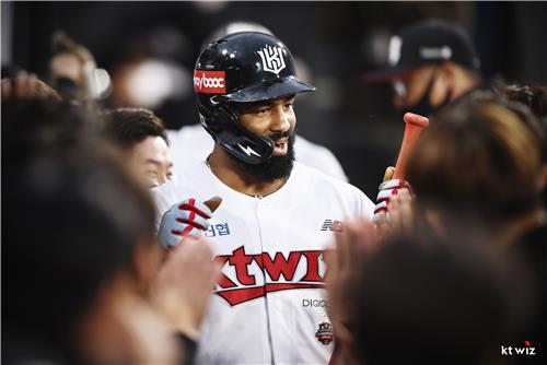 Henry Ramos of the KT Wiz is congratulated by teammates after hitting a two-run home run against Shin Min-hyeok of the NC Dinos during the bottom of the first inning of a Korea Baseball Organization regular season game at KT Wiz Park in Suwon, 45 kilometers south of Seoul, on April 22, 2022, in this photo provided by the Wiz. (PHOTO NOT FOR SALE) (Yonhap)