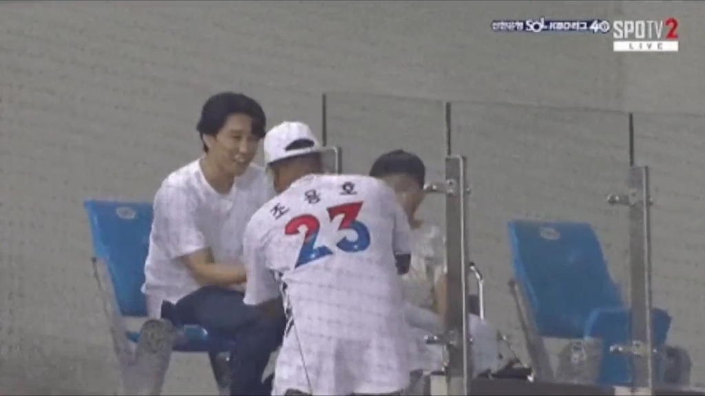 This image captured from a broadcast feed for a Korea Baseball Organization regular season game between the KT Wiz and the Doosan Bears on June 17, 2022, shows Jovian Turnbull (in KT Wiz No. 23 Cho Yong-ho jersey) handing a foul ball to the father of a boy in a wheelchair at Jamsil Baseball Stadium in Seoul. (PHOTO NOT FOR SALE) (Yonhap)
