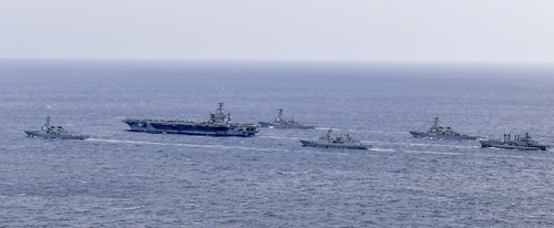South Korean and U.S. warships -- (from L to R) the South's Sejong the Great destroyer, the USS Nimitz aircraft carrier, the USS Wayne E. Meyer guided missile destroyer, the South's Choe Yeong destroyer, the USS Decatur destroyer and the South Korean Hwacheon logistics support ship -- stage maritime drills south of the southern island of Jeju on March 27, 2023, in this photo provided by the South's Navy. (PHOTO NOT FOR SALE) (Yonhap)