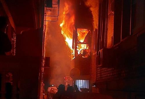 This photo provided by fire authorities shows a fire burning the interior of a residential building in Ansan, 30 kilometers south of Seoul, on March 27, 2023. (Yonhap)