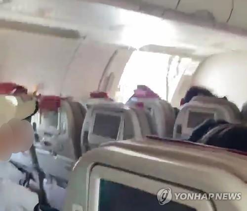 This image provided by a reader shows an opened airplane door during a flight on May 26, 2023. (PHOTO NOT FOR SALE) (Yonhap)
