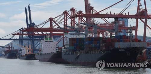 Containers for exports and imports are stacked at a pier in South Korea's largest port city of Busan, 320 kilometers southeast of Seoul, on July 25, 2023. (Yonhap)