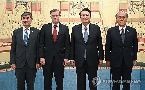 This photo, provided by the presidential office, shows President Yoon Suk Yeol (2nd from R), National Security Adviser Cho Tae-yong (L), U.S. National Security Advisor Jake Sullivan (2nd from L) and Japan's National Security Secretariat Secretary General Takeo Akiba ahead of their dinner meeting at the presidential residence in Seoul on Dec. 8, 2023. (PHOTO NOT FOR SALE) (Yonhap)