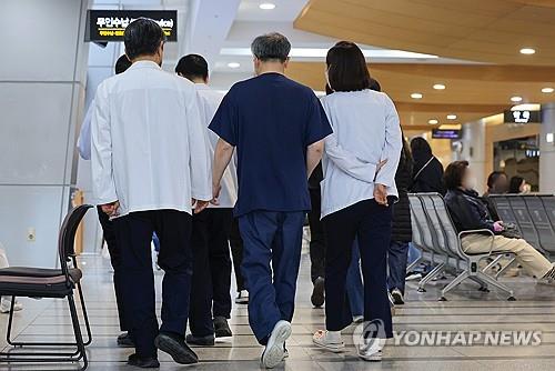 Medical workers move inside a general hospital attached to a medical school on March 19, 2024. (Yonhap)