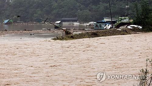 A stream in the southern county of Wanju remains swollen after record rainfall pounds North Jeolla Province on July 10, 2024. (Yonhap)