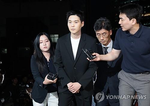 Suga of K-pop supergroup BTS (2nd from L), whose legal name is Min Yoon-ki, appears before Yongsan Police Station in Seoul on Aug. 23, 2024, to face questioning over his alleged drunk driving on an electric scooter earlier this month. (Yonhap)